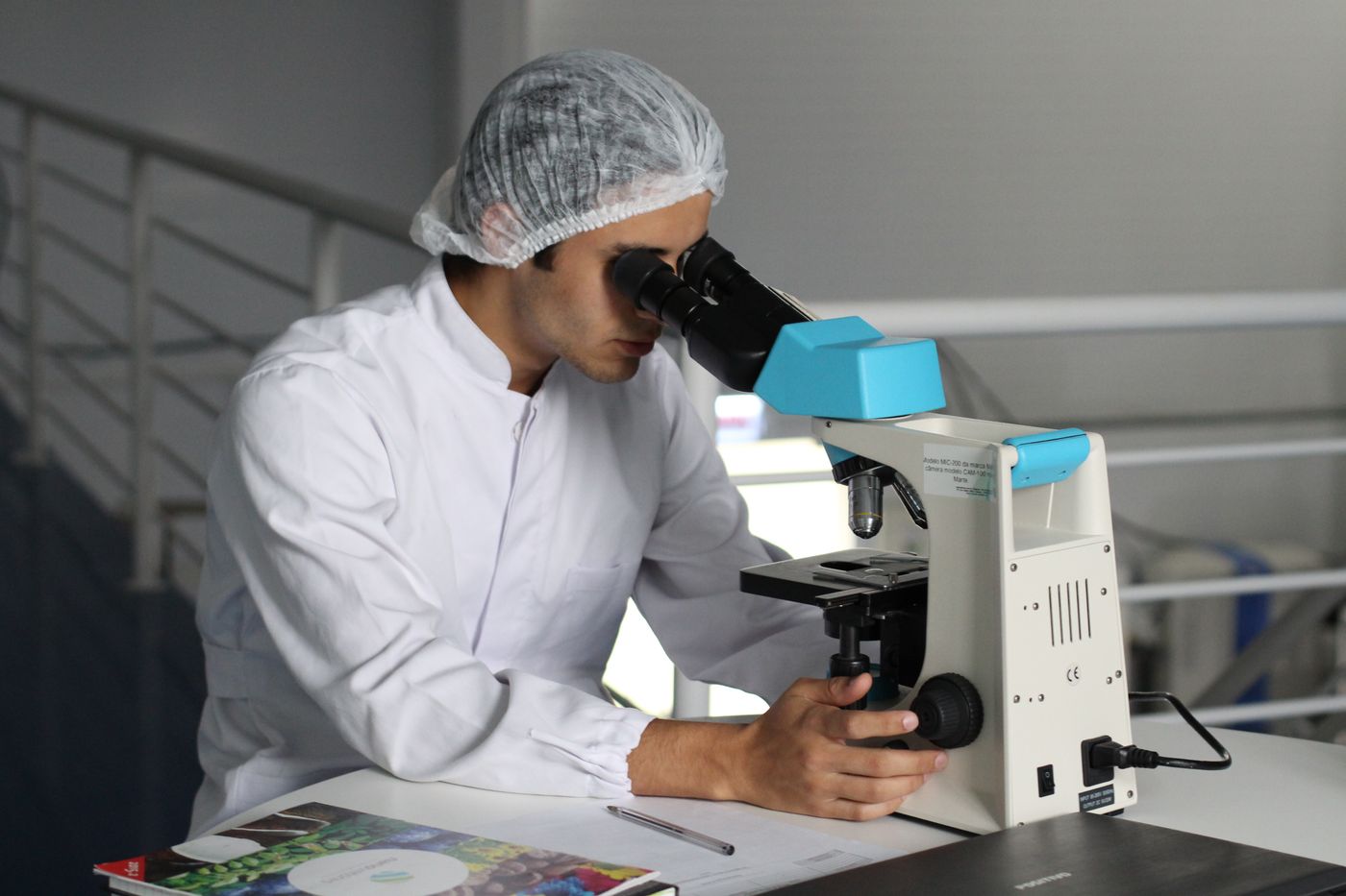 Laboratory technologist examining specimens under a microscope